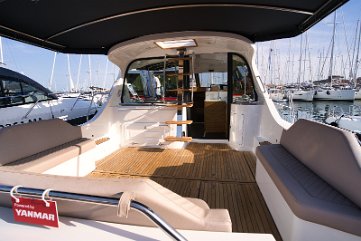 Seamless Connection on the Adriana yacht Wide glass doors connect the cockpit directly to the interior salon.