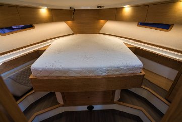 Spacious Forward Cabin Another view of the master cabin, highlighting the generous headroom and storage.