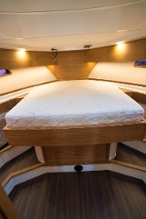 Master Suite Ambiance Elegant carpentry and comfortable bedding in the master cabin of 'Baby Blue'.