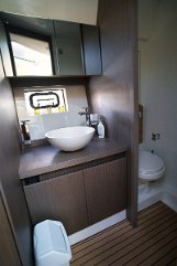 Bathroom & Shower - Beneteau 'Miami Vice' Well-appointed bathroom featuring storage cabinets and a separate shower area on the Gran Turismo 41.