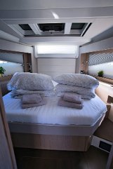 Owner's Suite Sealine C390 Natural light floods the master cabin through large hull windows and skylights, creating a bright atmosphere.