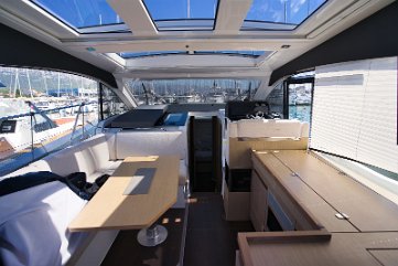 Open Atmosphere Large glass windows surround the salon, filling the interior with natural light.