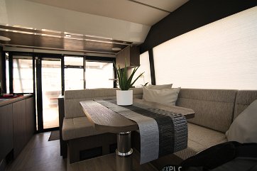 Interior Design Comfortable sofas and an adjustable table make the salon the perfect dining spot.