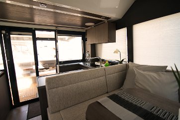 Sealine F430 Open Concept Salon Large glass doors connect the interior with the aft cockpit into one seamless space.