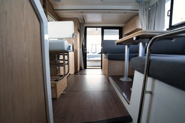 Seamless Indoor - Outdoor Living View looking aft towards the sliding glass doors, connecting the salon with the cockpit.